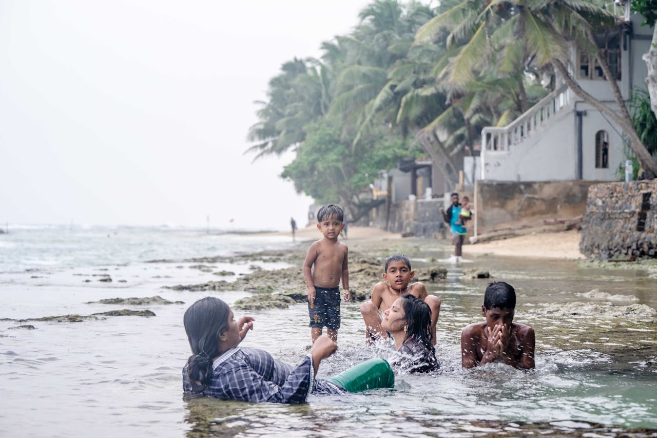 Crafting Captivating Headlines: Your awesome post title goes here Families splash and play near the shoreline in Galle, Sri Lanka, embracing summer fun.